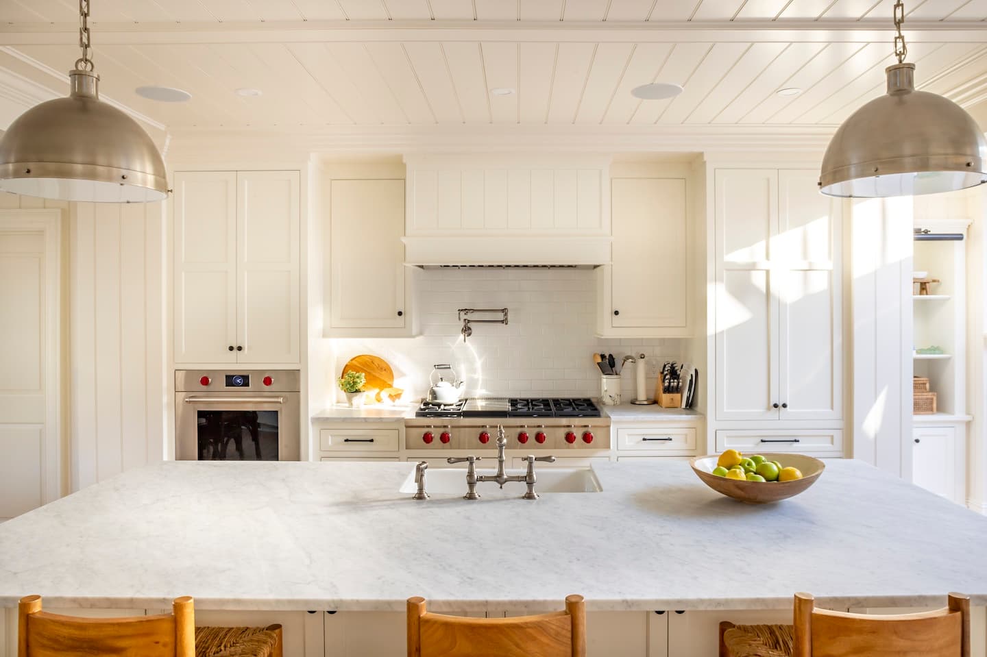 Modern kitchen with island, sink, stove, and fridge